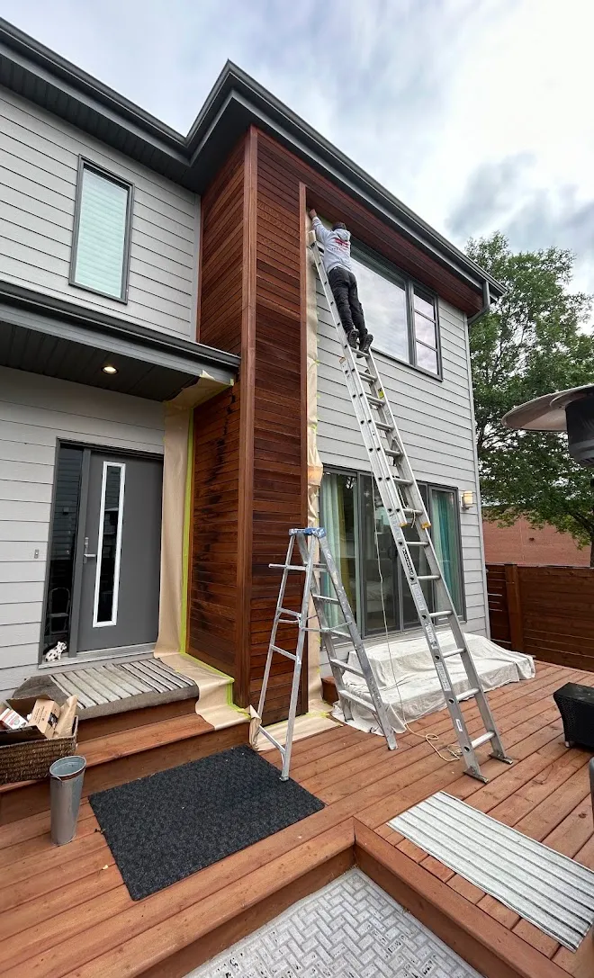 Repainted siding and exterior trim, masked and prepped mid-project — Leonard’s Painting, Edmonton area