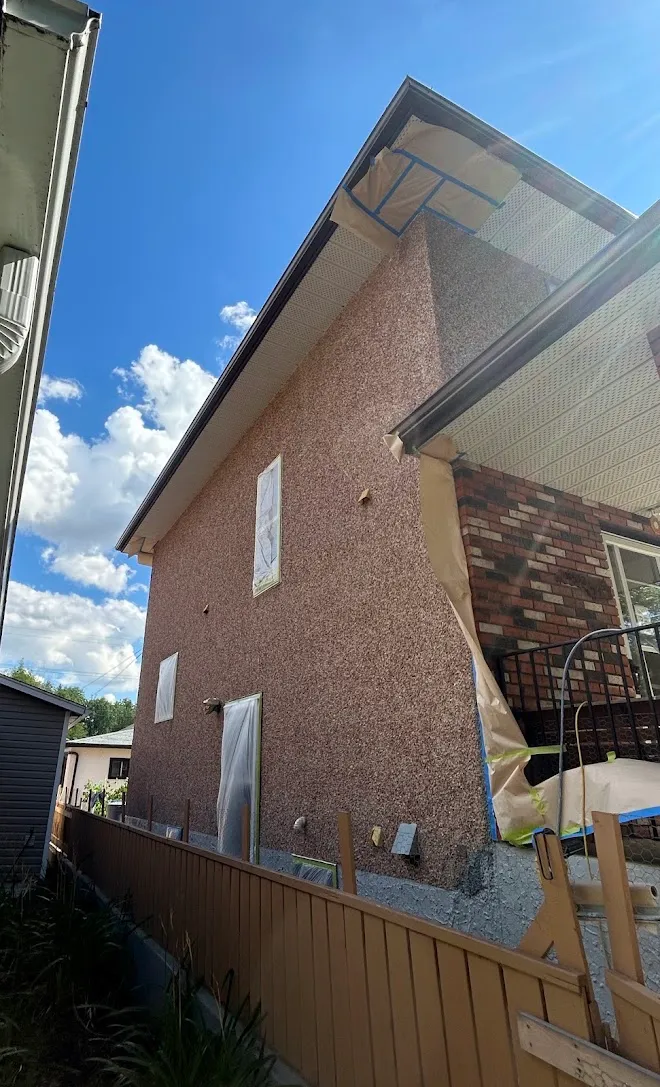 Home exterior, masked and prepped mid-project — Leonard’s Painting, Edmonton area