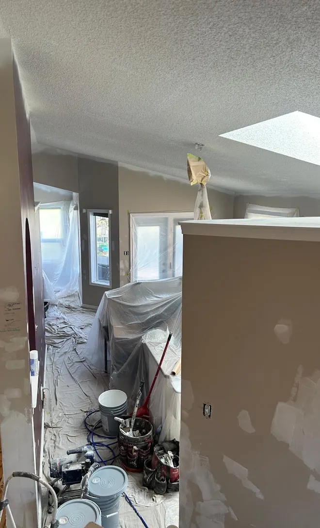 Freshly painted interior walls and ceilings, masked and prepped mid-project — Leonard’s Painting, Edmonton area