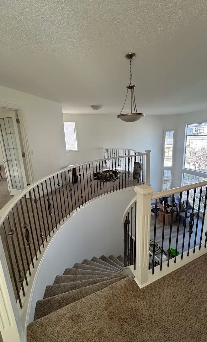Staircase spindles and railings with a fresh painted finish — Leonard’s Painting, Edmonton area