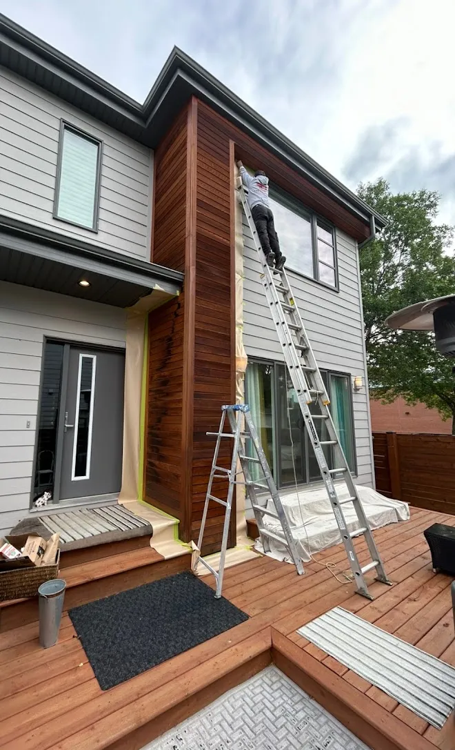 Home exterior, masked and prepped mid-project — Leonard’s Painting, Edmonton area