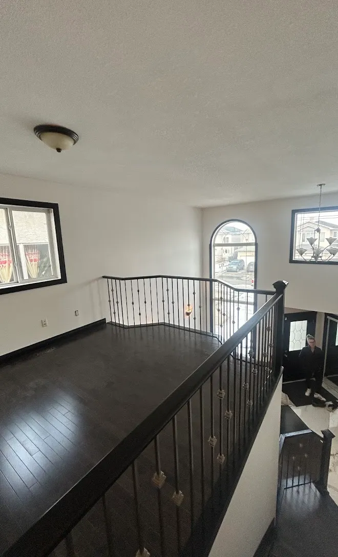 Refinished stair railings and spindles — Leonard’s Painting, Edmonton area