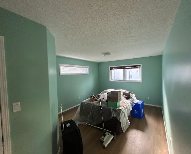 Repainted living space with clean lines and even coverage — Leonard’s Painting, Edmonton area