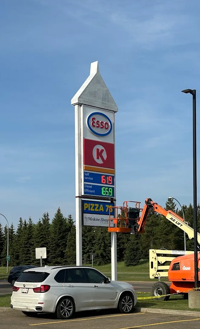 Boom lift repaint of a gas station sign — Leonard’s Painting, Edmonton area
