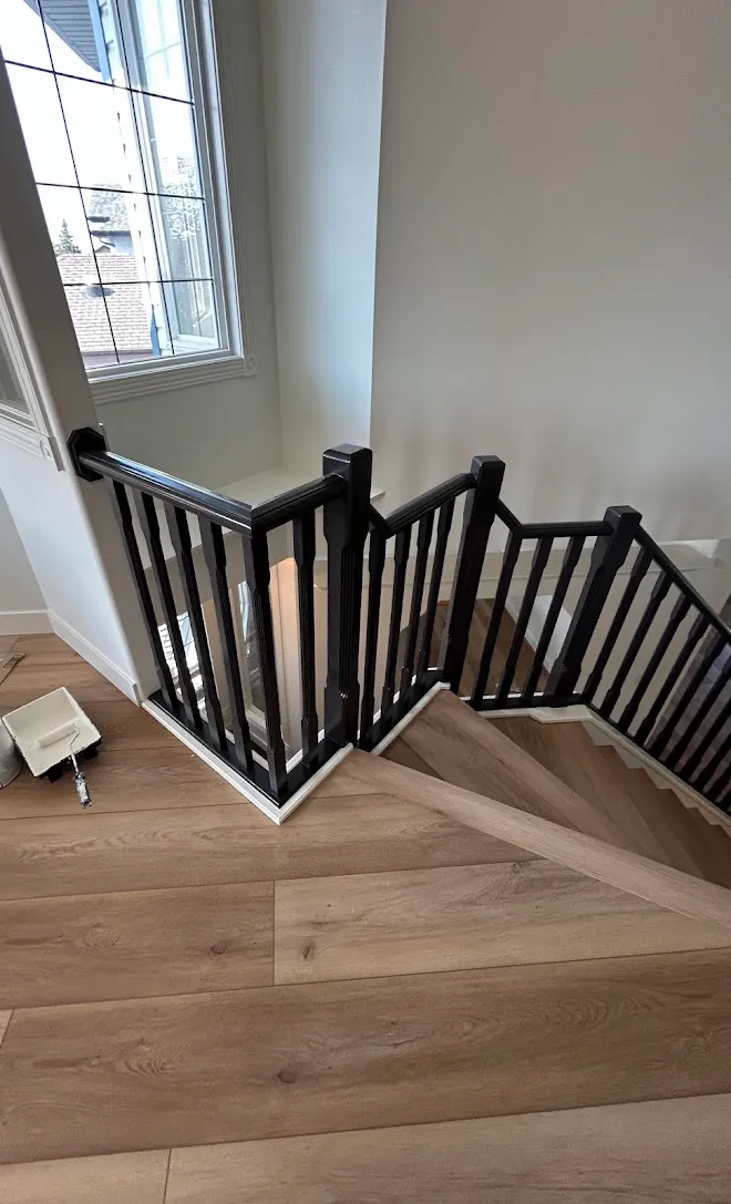 Staircase spindles and railings with a fresh painted finish — Leonard’s Painting, Edmonton area
