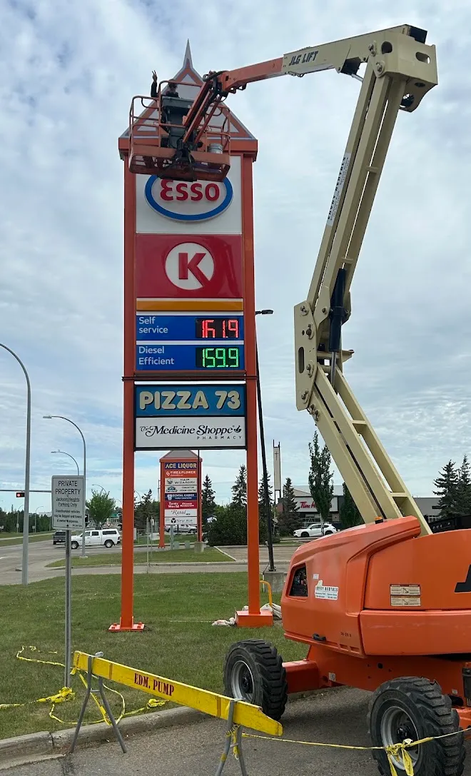 Boom lift positioned for a commercial sign repaint — Leonard’s Painting, Edmonton area