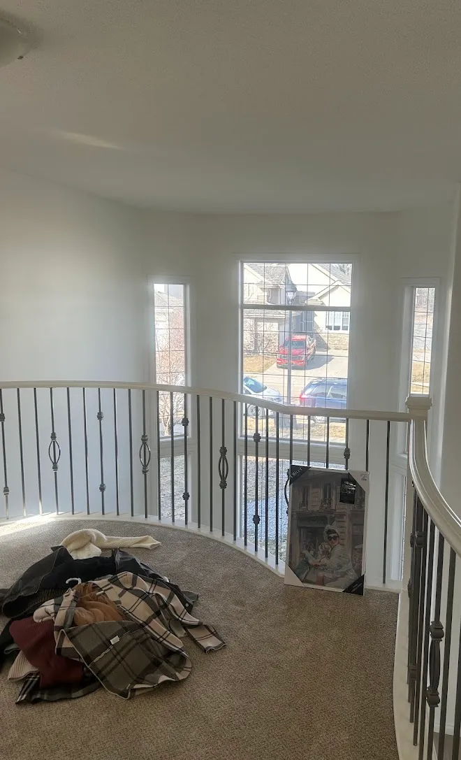 Repainted stairwell with crisp lines along the railing — Leonard’s Painting, Edmonton area