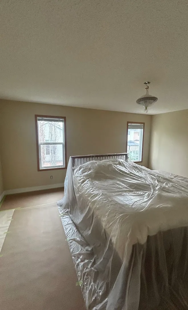 Repainted living space, masked and prepped mid-project — Leonard’s Painting, Edmonton area