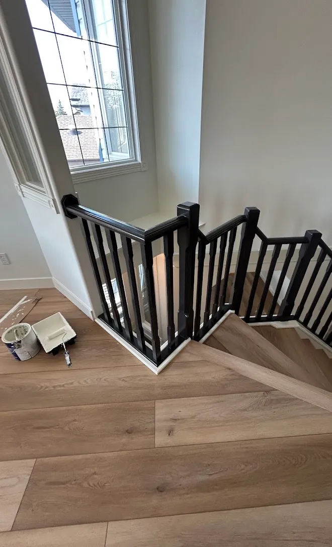 Refinished stair railings and spindles, masked and prepped mid-project — Leonard’s Painting, Edmonton area
